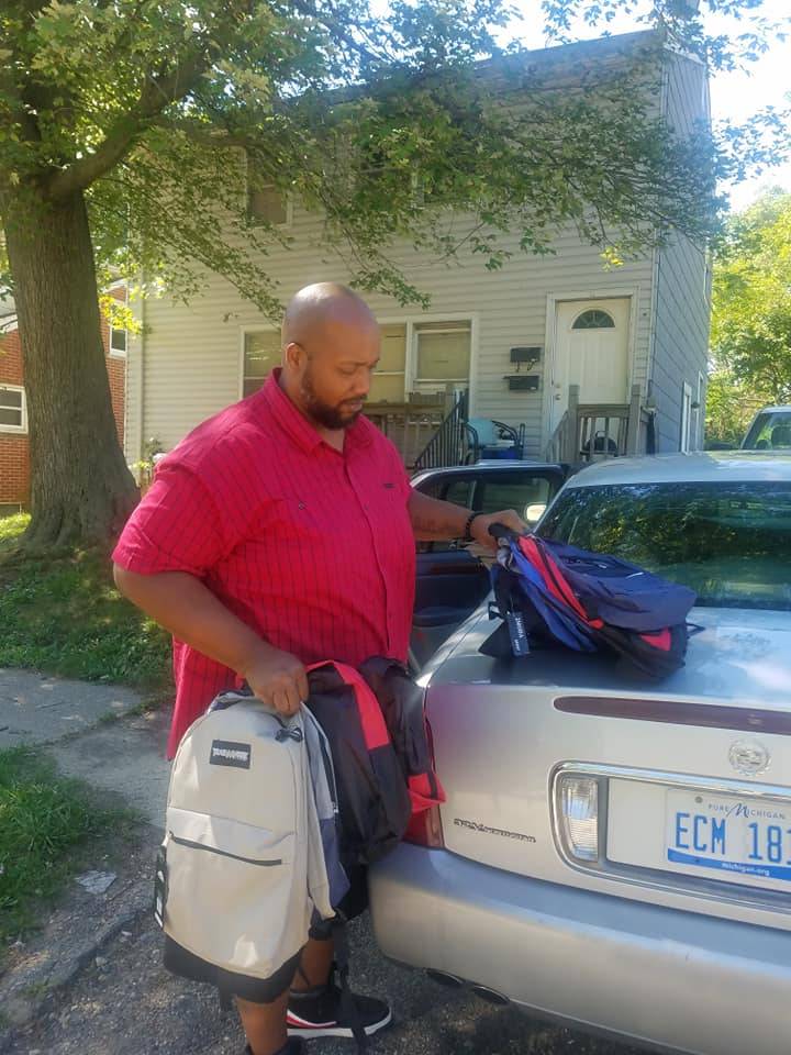 Volunteer with Backpacks for Pickup