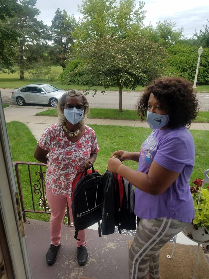 Volunteer Delivering Backpacks to a Family