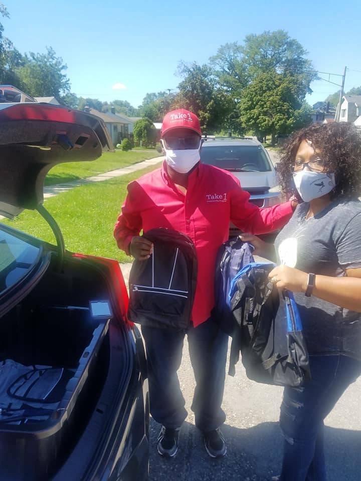 Volunteer Delivering Backpacks Curbside